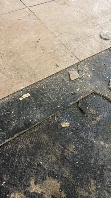 Black bitumen mastic floor removal in a N8 flat